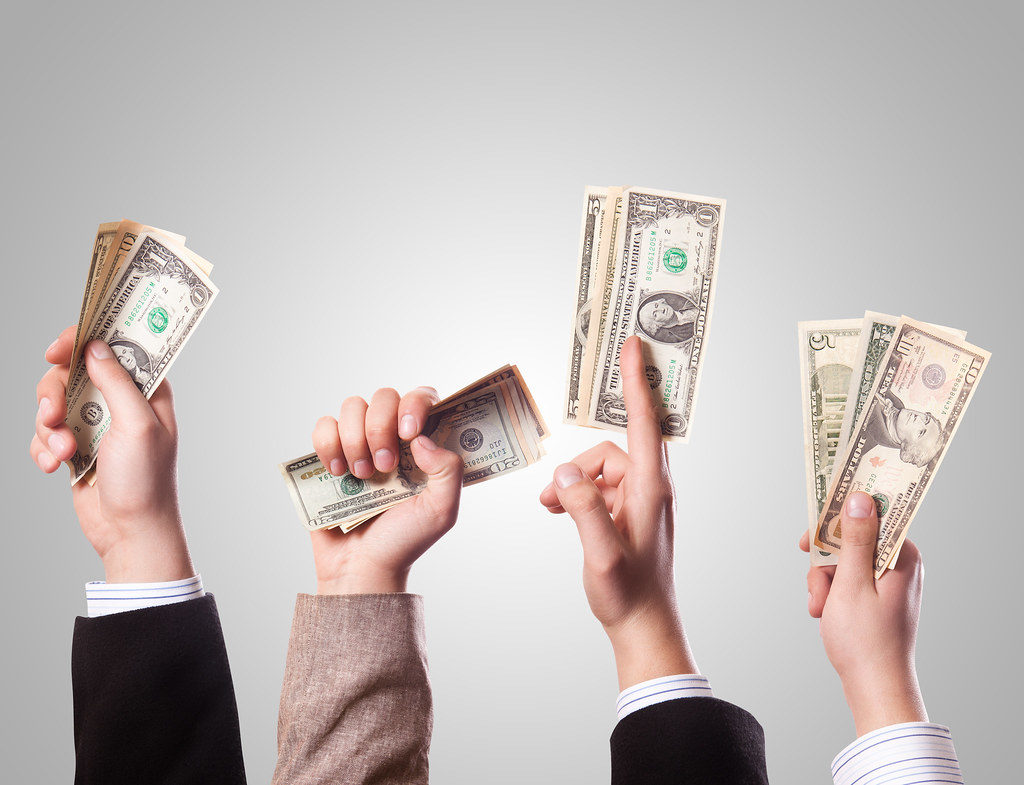Business people holding money