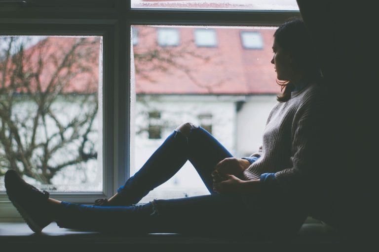 Woman sits in window