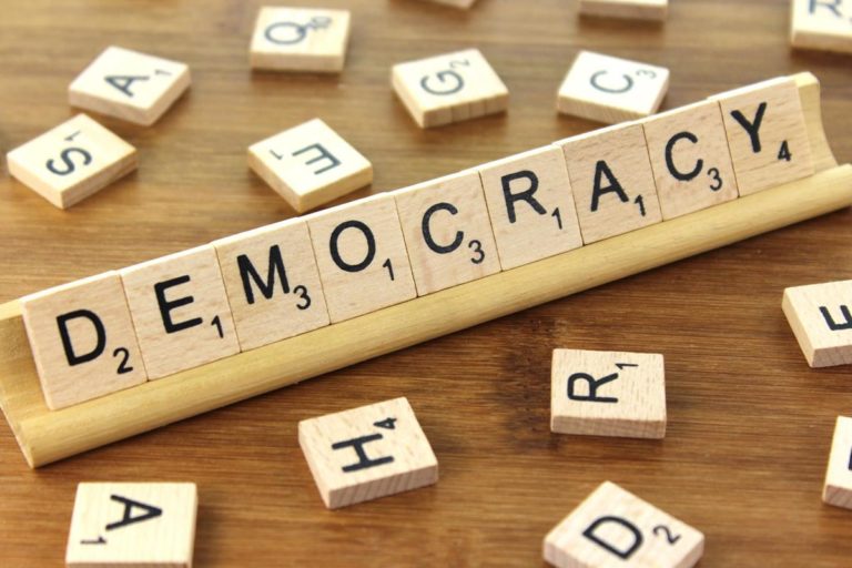 Scrabble letters that read 'Democracy'