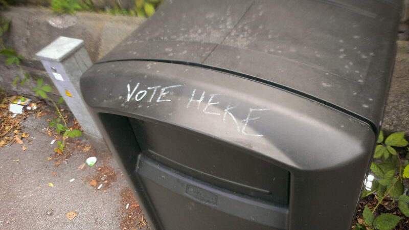 A bin with 'vote here' graffitied onto it