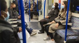 A photo of a London underground train run by TFL with passengers wearing masks