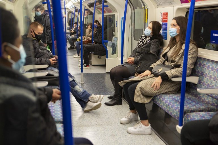 A photo of a London underground train run by TFL with passengers wearing masks