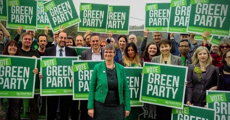 A photo of campaigners holding Green Party placards
