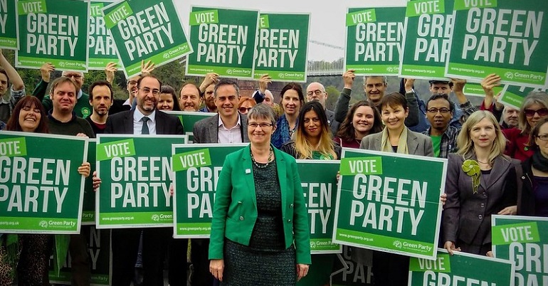 A photo of campaigners holding Green Party placards