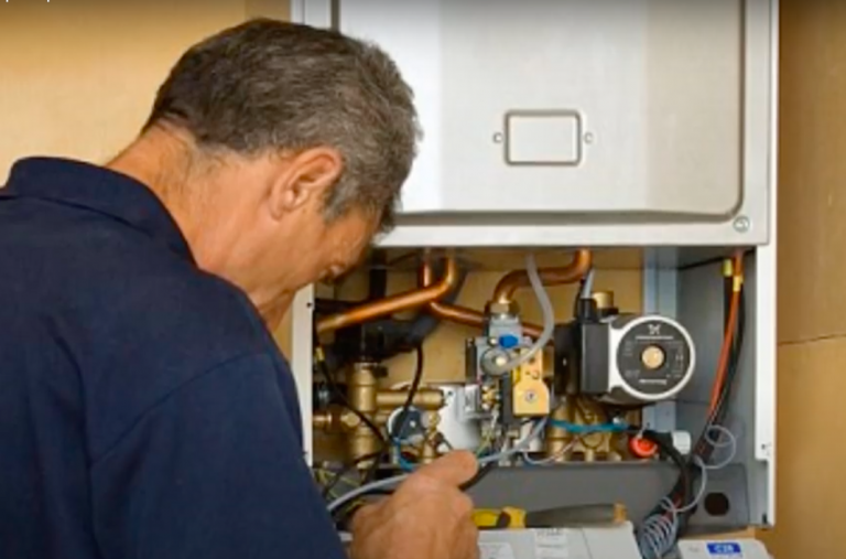 A mechanic repairing a boiler