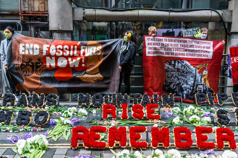 Protesters from Coal Action Network set up a climate justice memorial at Lloyd’s of London.