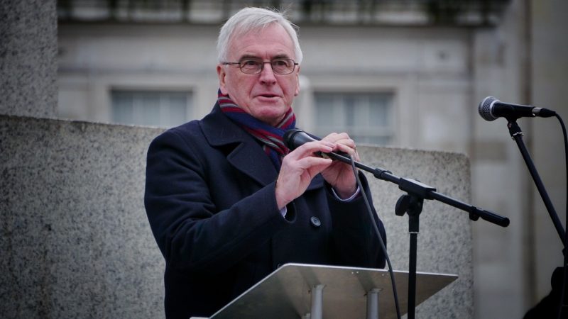 John McDonnell speaking at a lectern outdoors