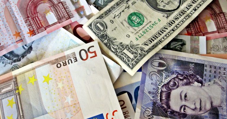 A pile of banknotes from around the world