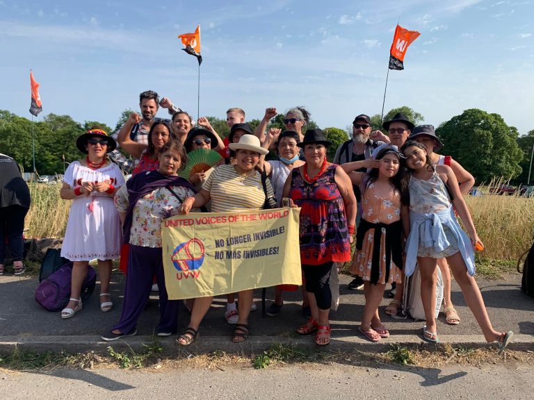 Members of the UVW Union with a banner reading "United Voices of the World"