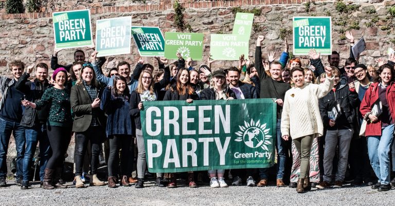 Green Party campaigners holding a Green Party banner in Bristol