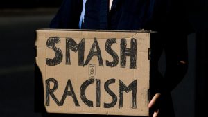 A placard reading smash racism
