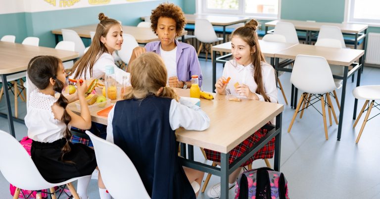 Children eating a meal in a school canteen
