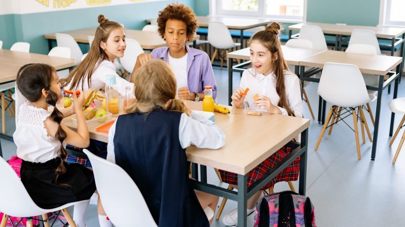 Children eating a meal in a school canteen