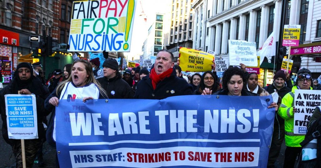 A photo of a march coinciding with RCN strikes. Demonstrators are carrying a banner reading "We are the NHS!"