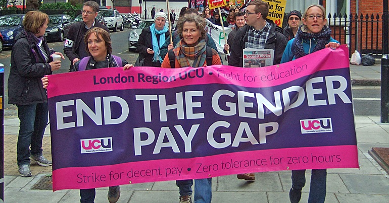 A photo of UCU members marching behind a banner reading "End the Gender Pay Gap"
