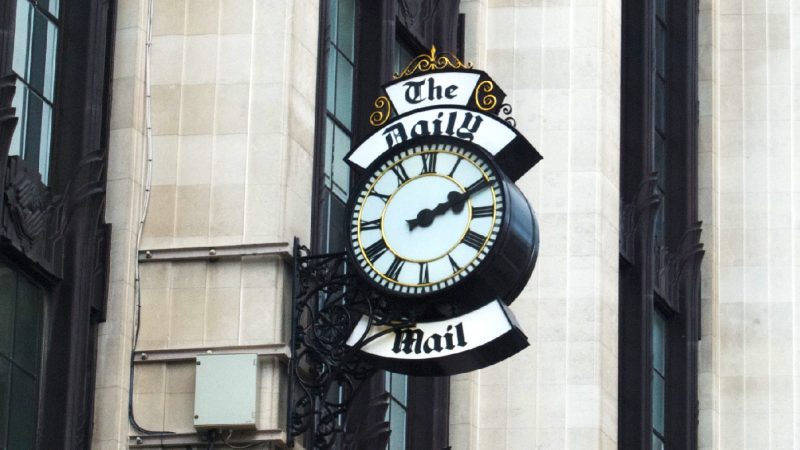 A clock with the words "The Daily Mail"