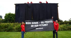 Greenpeace protesters draping black cloth around Rishi Sunak's home