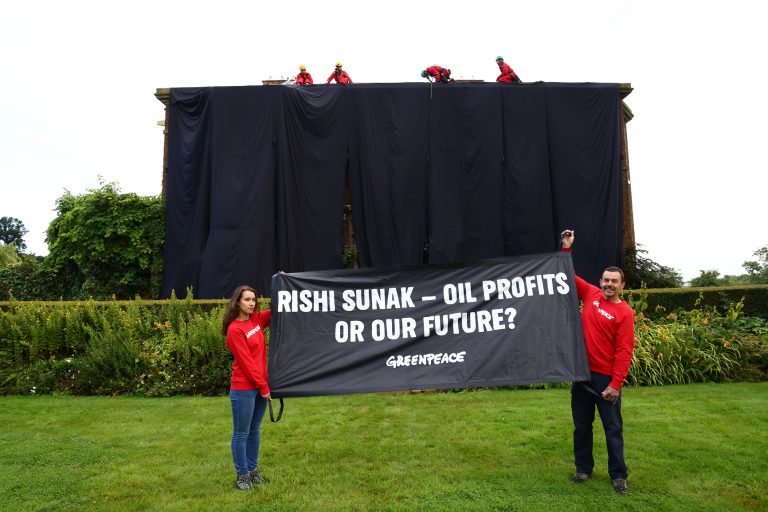 Greenpeace protesters draping black cloth around Rishi Sunak's home