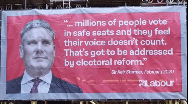 A banner dropped at Labour HQ quoting Keir Starmer's comments on PR from 2020