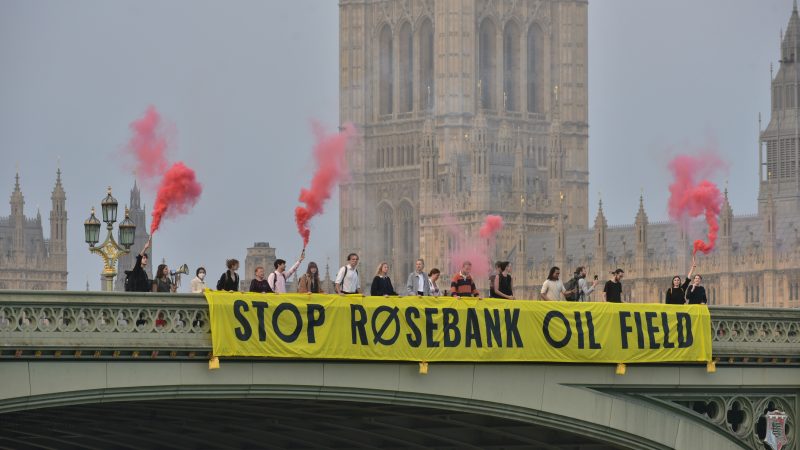 Climate campaigners dropping a banner reading "Stop Rosebank Oil Field" on Westminster Bridge