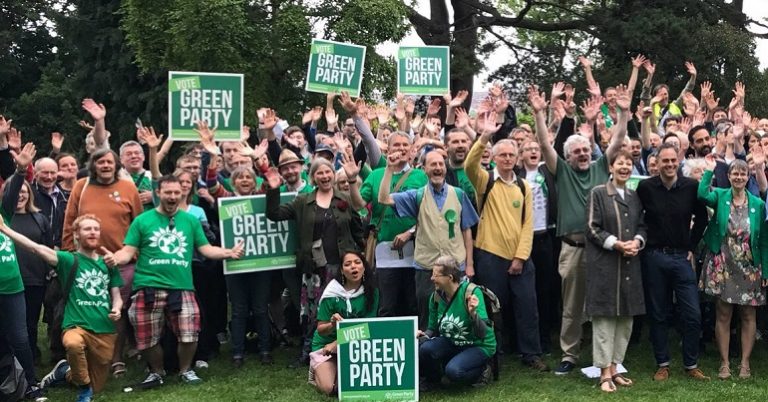 Green Party activists holding placards