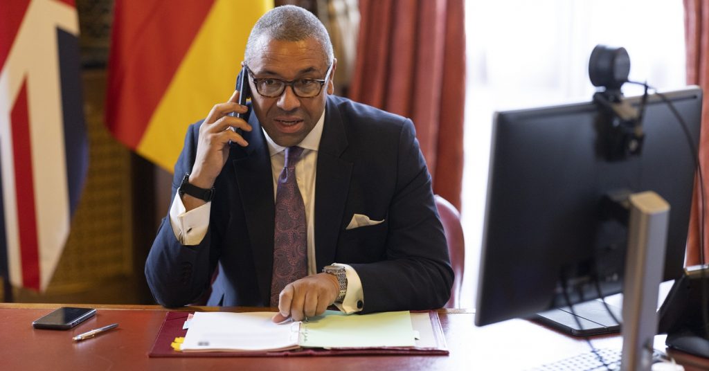 James Cleverly on a mobile phone