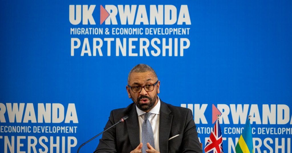 Home Secretary speaking at an event in front of a sign reading UK Rwanda Partnership