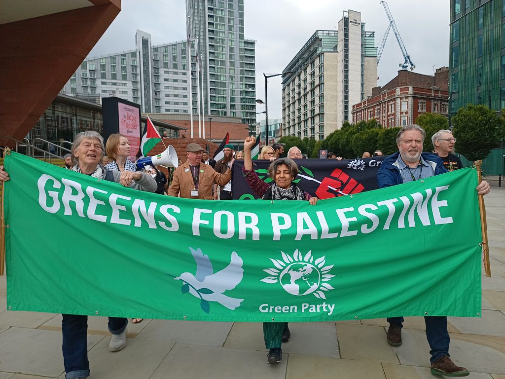 A group of Green Party members with a banner reading 'Greens for Palestine'