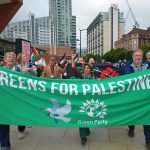 A group of Green Party members with a banner reading 'Greens for Palestine'