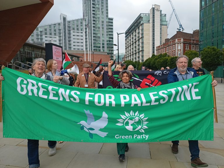 A group of Green Party members with a banner reading 'Greens for Palestine'