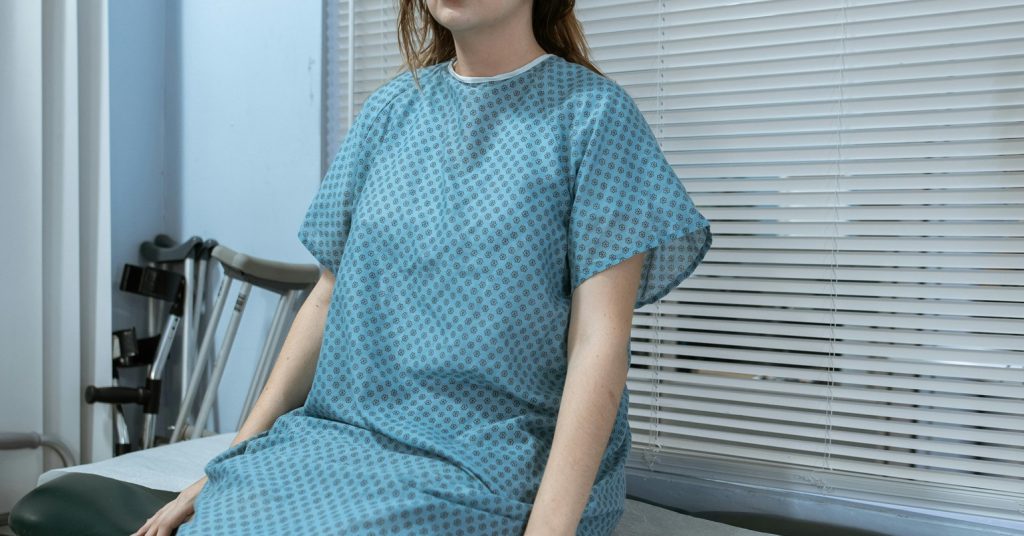 A woman in a hospital gown