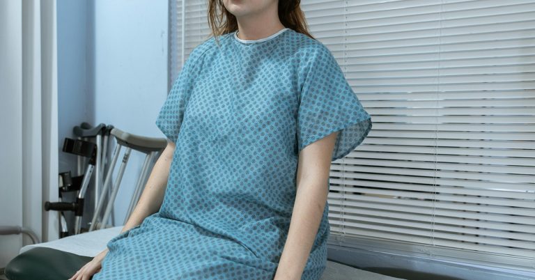 A woman in a hospital gown