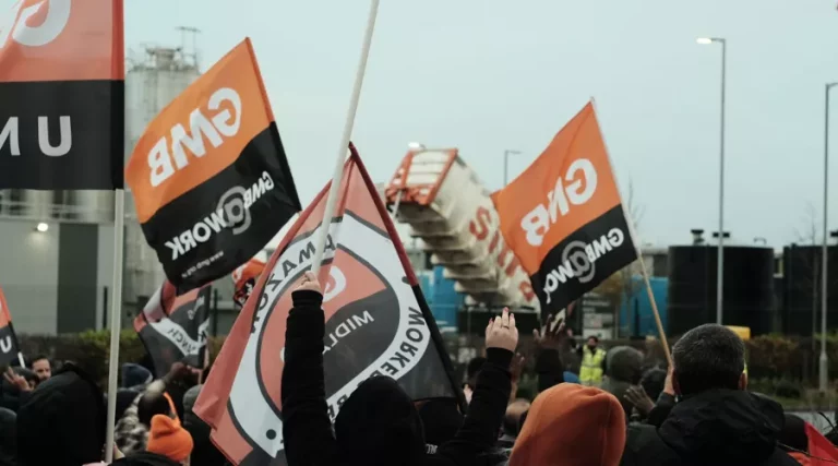 A photo of GMB union members waving GMB flags at a protest or strike