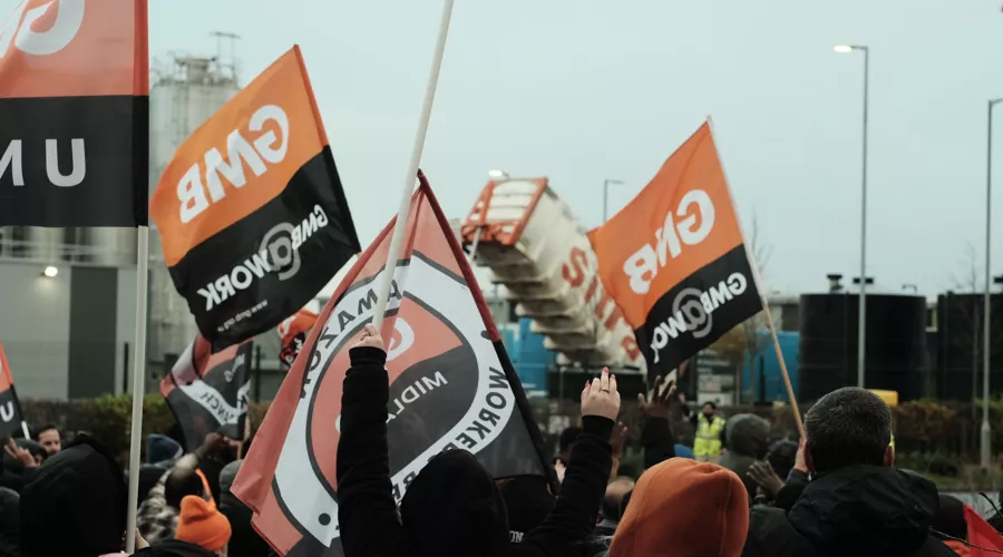 A photo of GMB union members waving GMB flags at a protest or strike