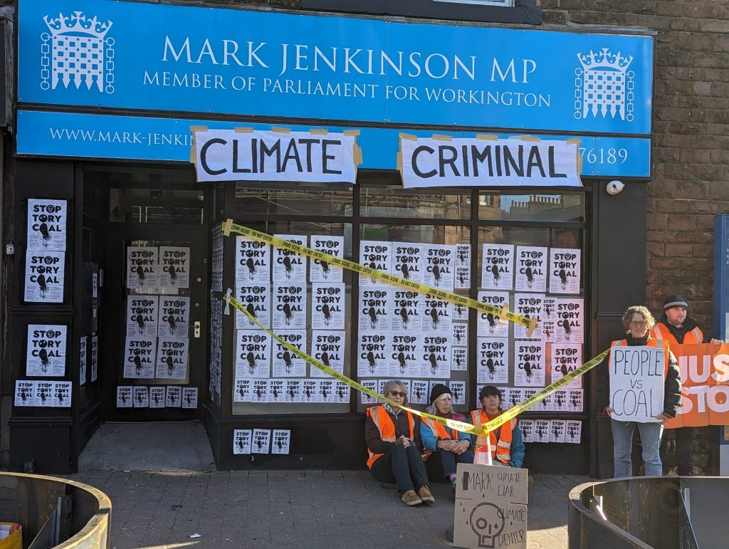 A photo of former MP Mark Jenkinson's office covered in 'Stop Tory Coal' posters