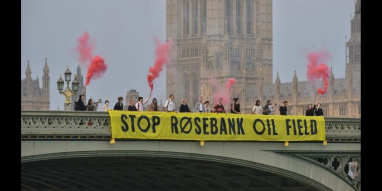 Climate campaigners dropping a banner reading "Stop Rosebank Oil Field" on Westminster Bridge