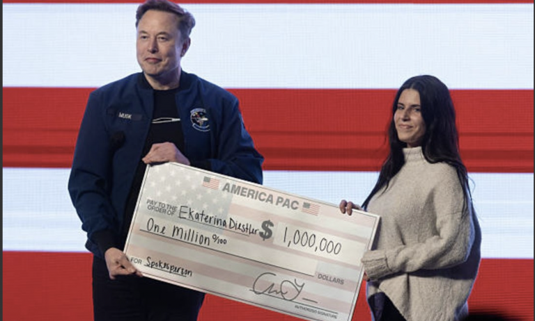 A photo of Elon Musk handing a $1 million cheque to a Wisconsin voter
