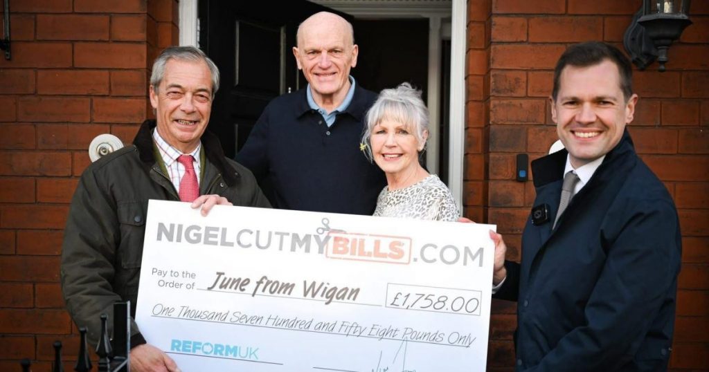 Nigel Farage posing with the winners of his energy bill giveaway