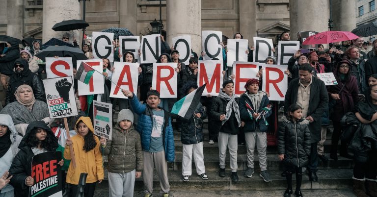 A photo of protesters with signs that read "genocide Starmer"