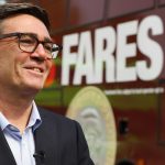 Andy Burnham in front of a bus advertising the £2 bus fare cap