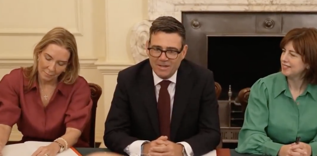 A photo of Burnham holding his first cabinet meeting