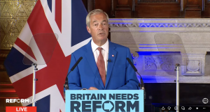 A photo of Nigel Farage speaking at a Reform press conference