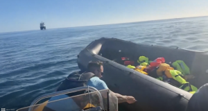 A photo of far-right activist Daniel Thomas attacking a dinghy